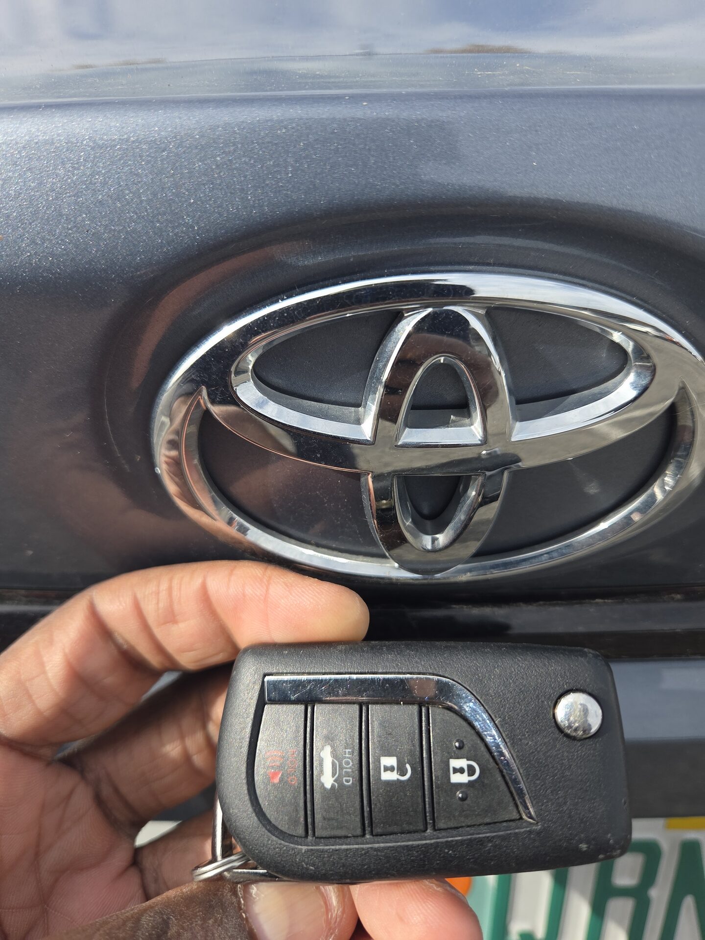 Programmed key fob held against a vehicle badge