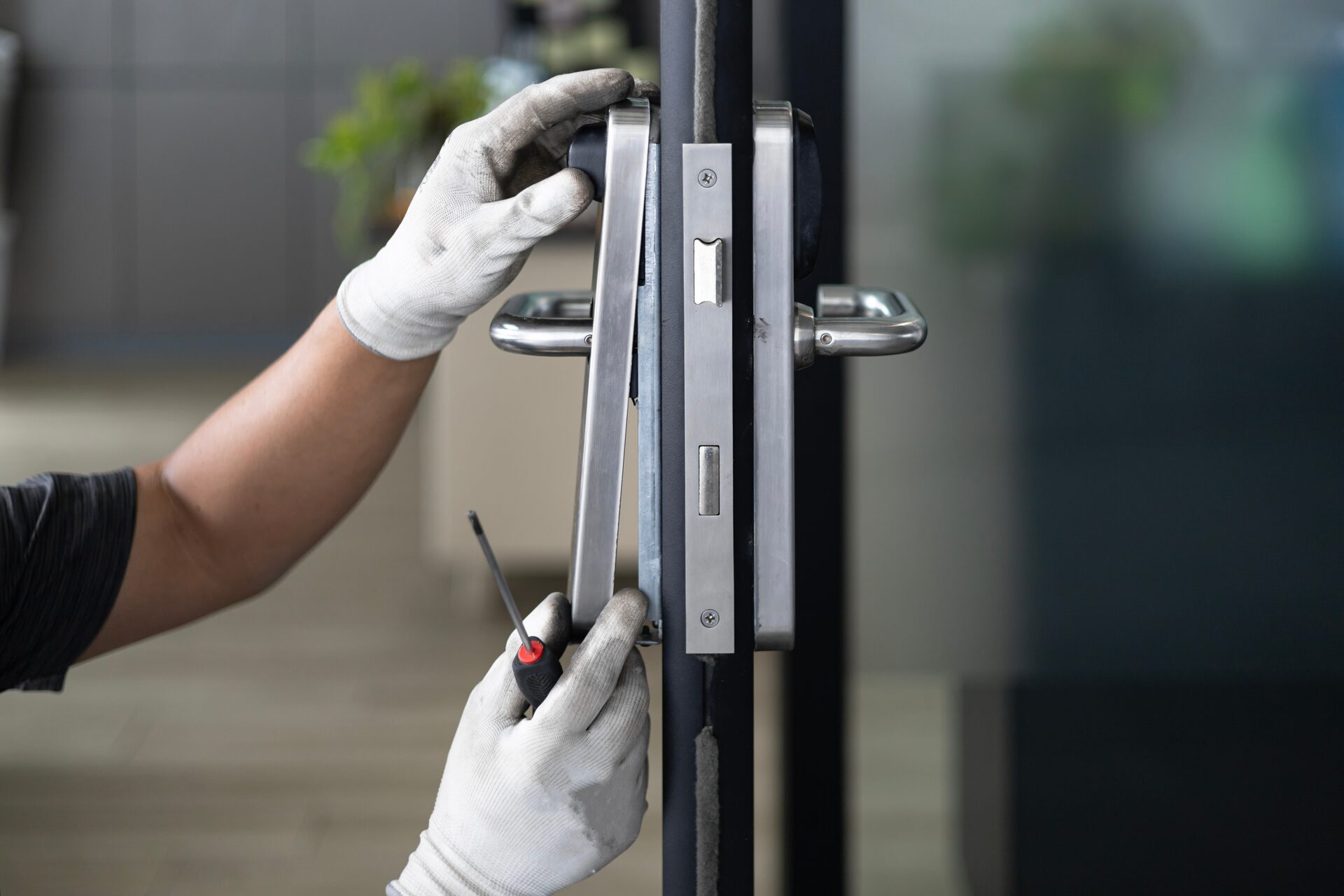 Technician installing a commercial door lock